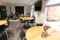 Gallery Photo of Dining room, complete with live music, plenty of natural lighting, and fresh cut flower arrangements
