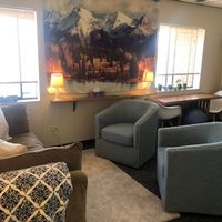 Gallery Photo of Walking into my office, see comfortable couch and chairs, play and family therapy space, play and art closet, two windows letting in natural sunlight