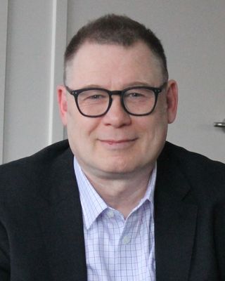 Photo of Dr Alex Kelemen, Psychotherapist, PsychD, AMHSW