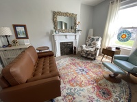 Gallery Photo of Have a seat on the couch, recline, or relax near the fireplace, we have your back.