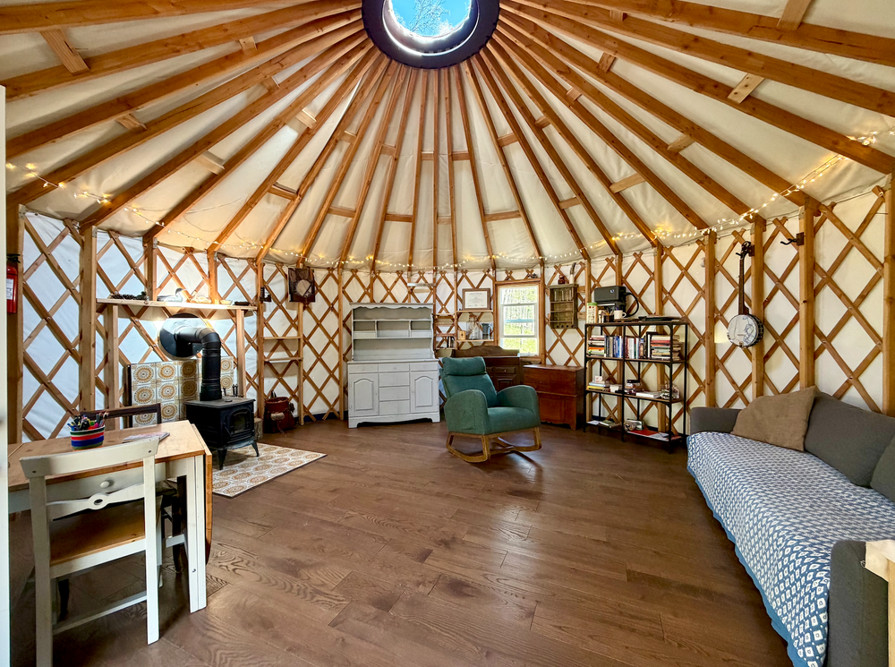 my yurt-style office is designed to be a comfortable setting that integrates the surrounding natural environment