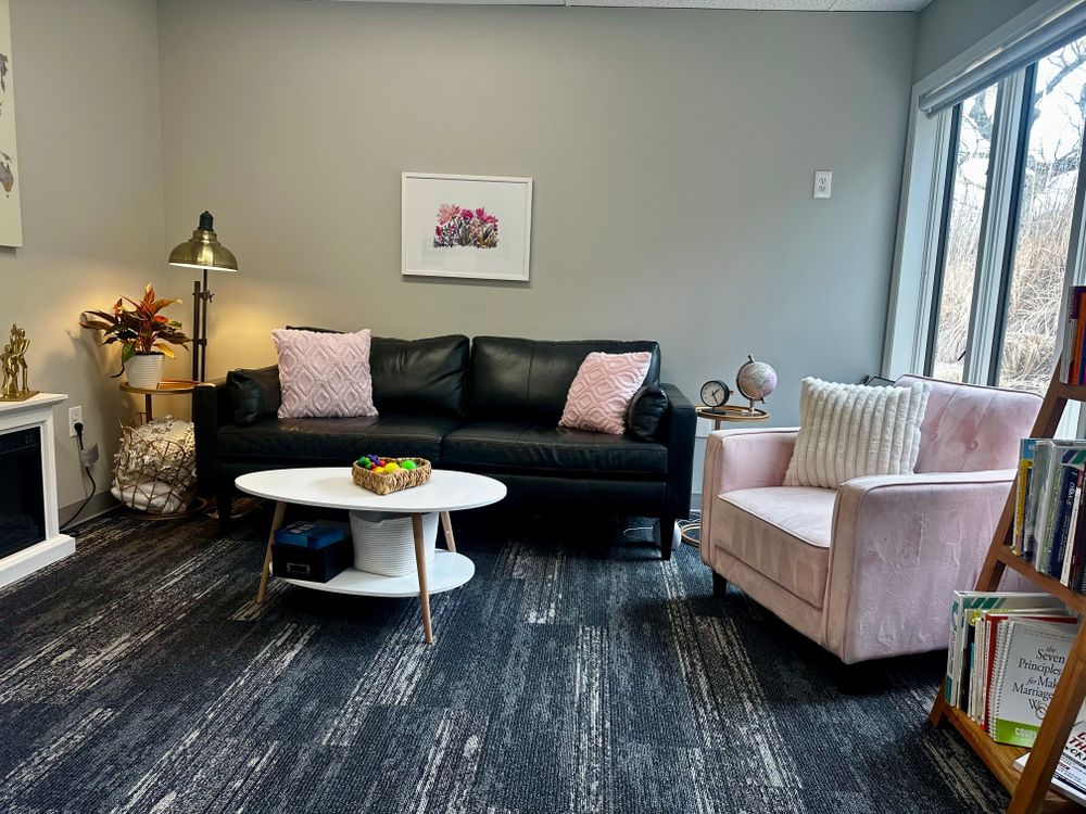 My therapy office is a cozy, serene space filled with soft pink tones that instantly create a sense of calm.