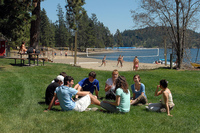 Gallery Photo of Students study group by lake on Campus