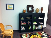 Gallery Photo of Our waiting room, which doubles as a library, with books our clients can leaf through while waiting or borrow to read at home.