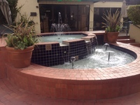Gallery Photo of Serene water feature with seating.