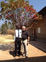 Gallery Photo of My friend and I in Africa standing under a poinsettia tree.