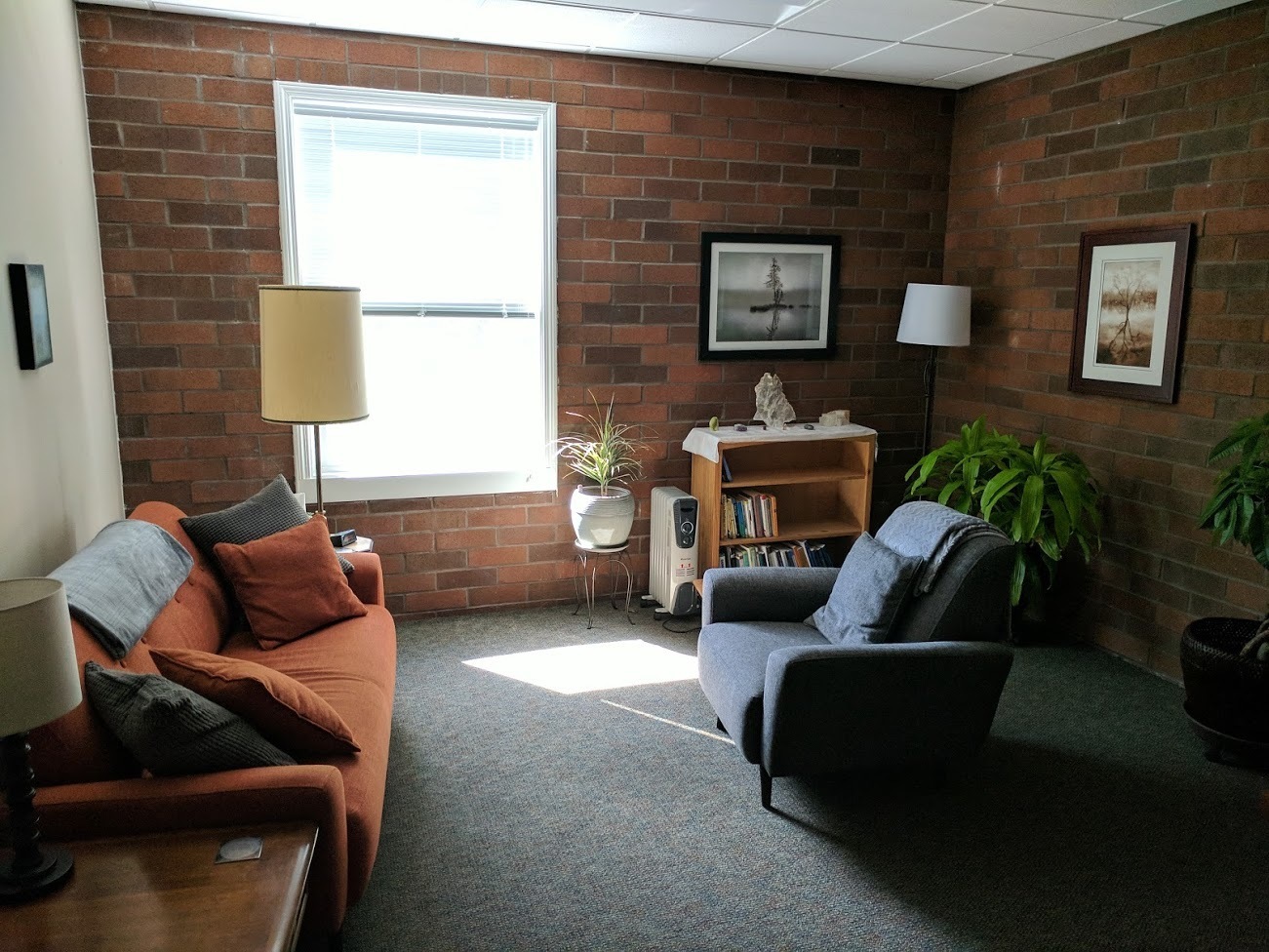 Gallery Photo of Spacious office with natural light, plants, art, and a comfy couch!