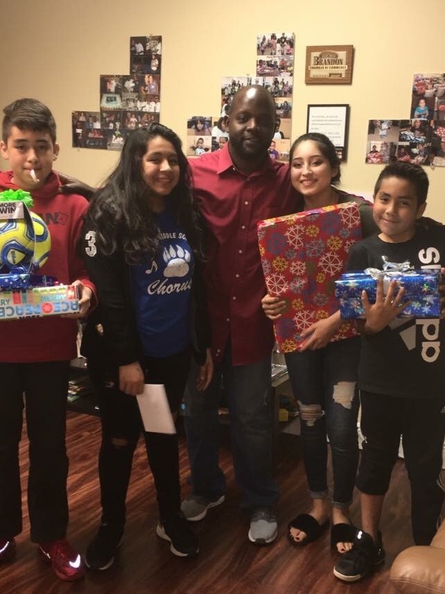 Gallery Photo of A family happily receiving items from our yearly Toy Drive.