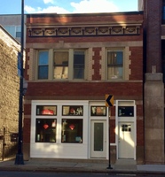 Gallery Photo of The outside of the building at 4910 N. Lincoln Ave. Chicago, IL 60625. The main entrance is through the gate on the left.