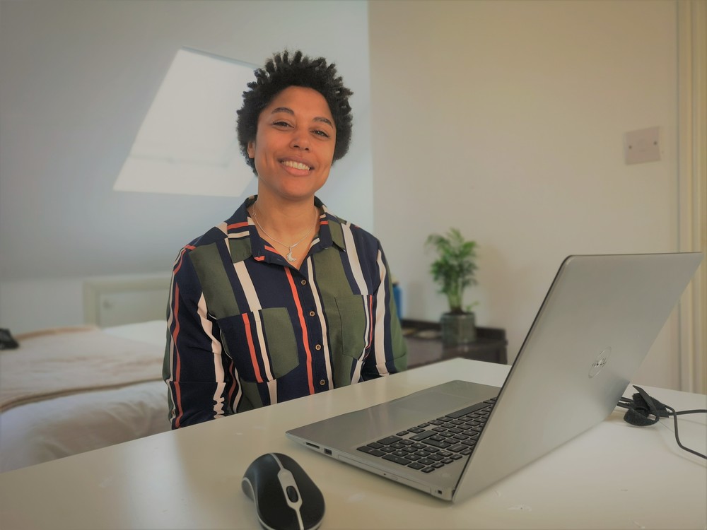Emma sitting at desk with laptop