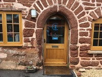 Gallery Photo of This is the main entrance to the side of the  building with its beautifully crafted door and rustic arch