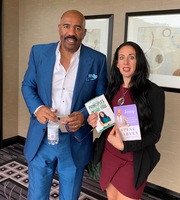 Gallery Photo of Dr. Cali Estes with Steve Harvey discussing books and law of attraction