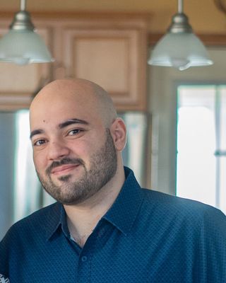 Photo of Arbin Memisi, Counselor, LCPC, NCC