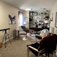 Gallery Photo of Amelia's office is inviting for anyone wanting to do trauma therapy. A light bar on the left is for EMDR. 