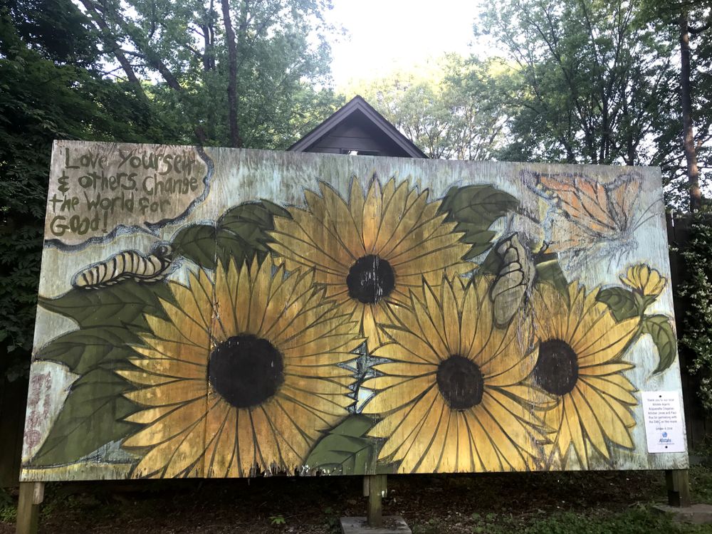 Art in the Park - for inspiration. (Picture of flower mural in public park with words, "Love yourself & others and change the world for good.")