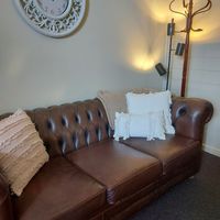 Gallery Photo of Relaxing leather couch with soft cushions.