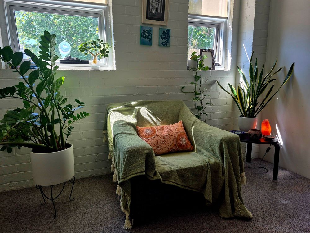 Welcome to my therapy room with natural light, airflow, and fidget toys. Feel free to kick off your shoes and get comfy. Ceiling lights optional.