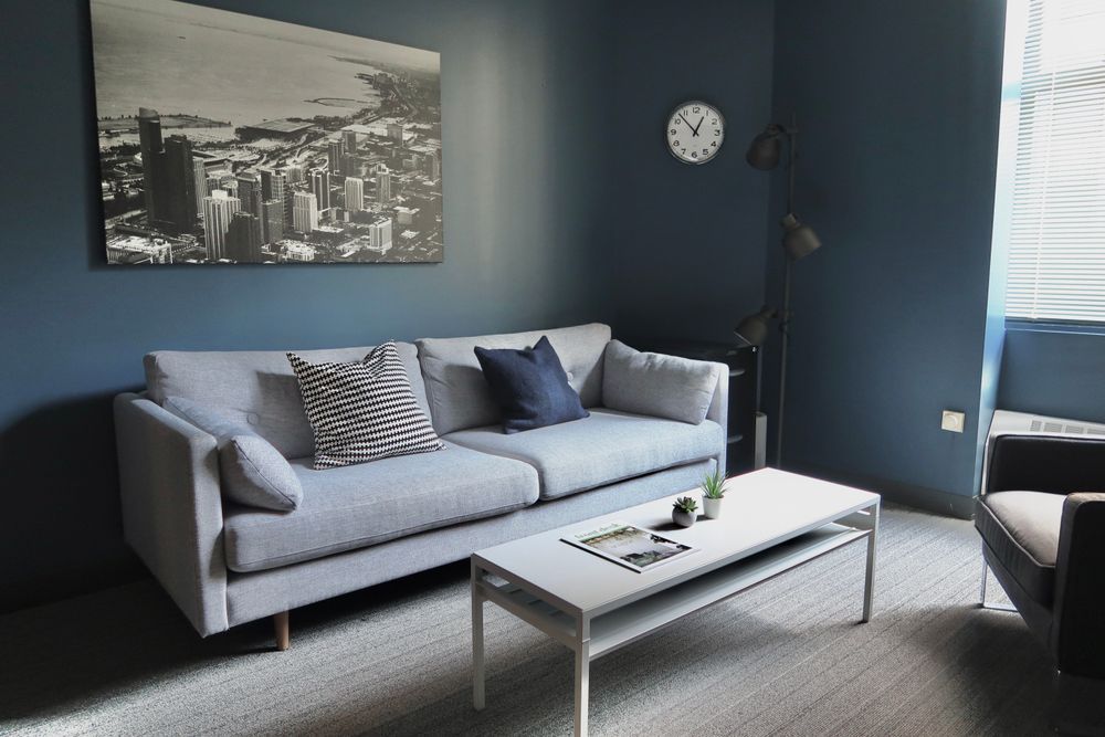 Sessions take place in one of several thoughtfully furnished therapy rooms within our shared office.