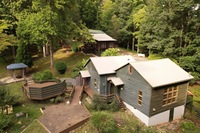 Gallery Photo of Cabins, offices, movement space, outdoor treatment spaces for nature and psychedelic therapy.