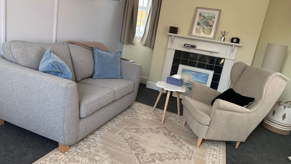 A warm welcome to my therapy room in the heart of Stratford-upon-Avon, offering a calm and comfortable space for reflection and healing