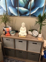 Gallery Photo of Chime used for guided meditations & mindfulness exercises, scented lotions for aroma therapy, plants & statue evoke health & harmony.