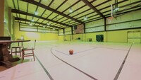 Gallery Photo of Official size basketball court. The rims are set at professional regulation 10' height. Equipment for volleyball and ping pong are available.