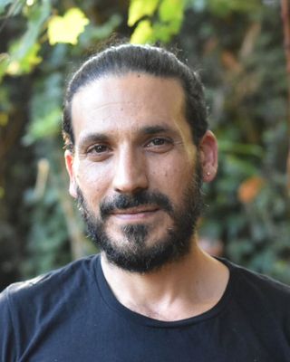 Photo of Alon Yizhak, MA, PLPC, MT-BC