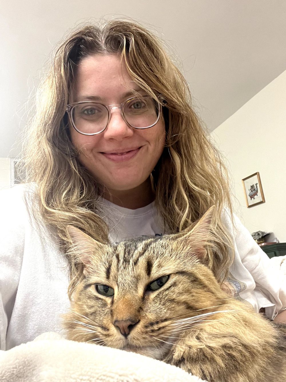 Snuggling with one of my two cats, Percy.