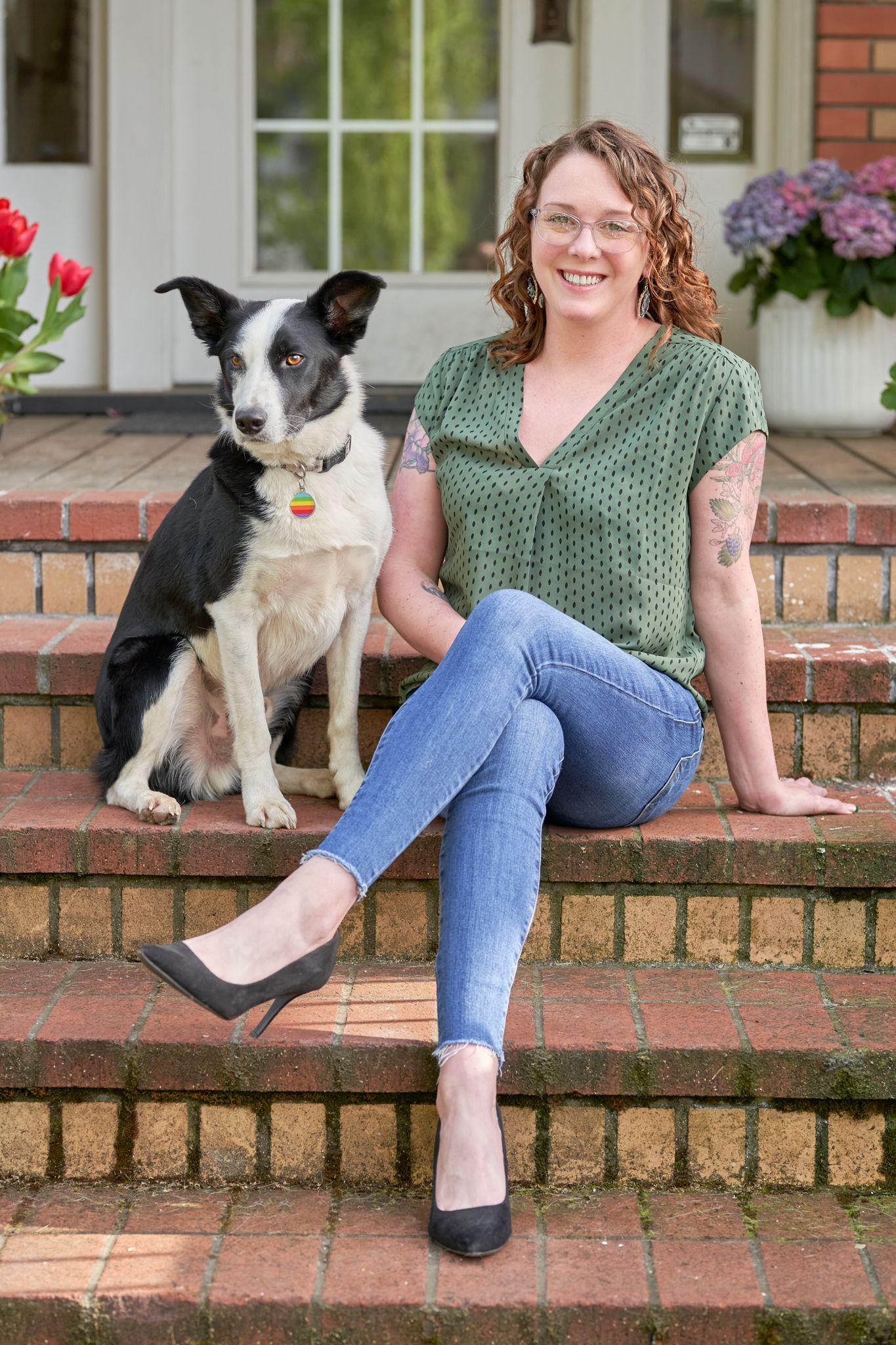 Gallery Photo of Kara and Baxter sitting on the steps of Ancora Wellness. 