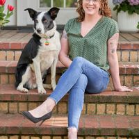 Gallery Photo of Kara and Baxter sitting on the steps of Ancora Wellness. 