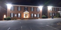 Gallery Photo of Parking Lot and Front of Building at Night.  Plenty of lighting for safety at night.