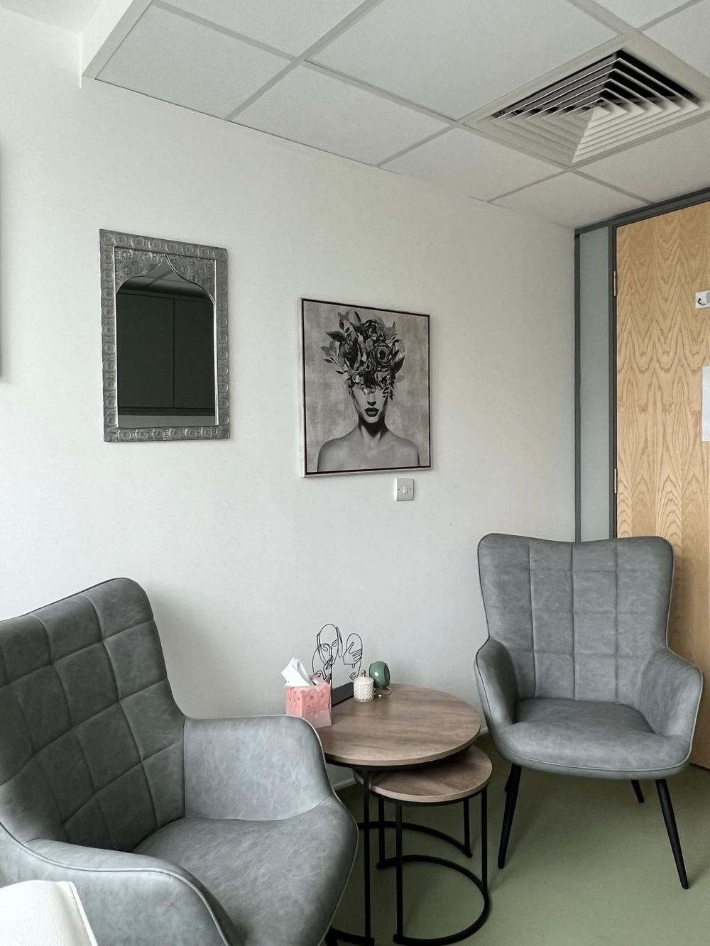 A calm, private therapy room in Cavendish Square with soothing décor, soft lighting, and comfortable seating,  in a central London.