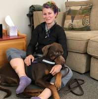 Gallery Photo of Furry co-therapist and service dog Pandora hard at work with owner/mom Vanessa